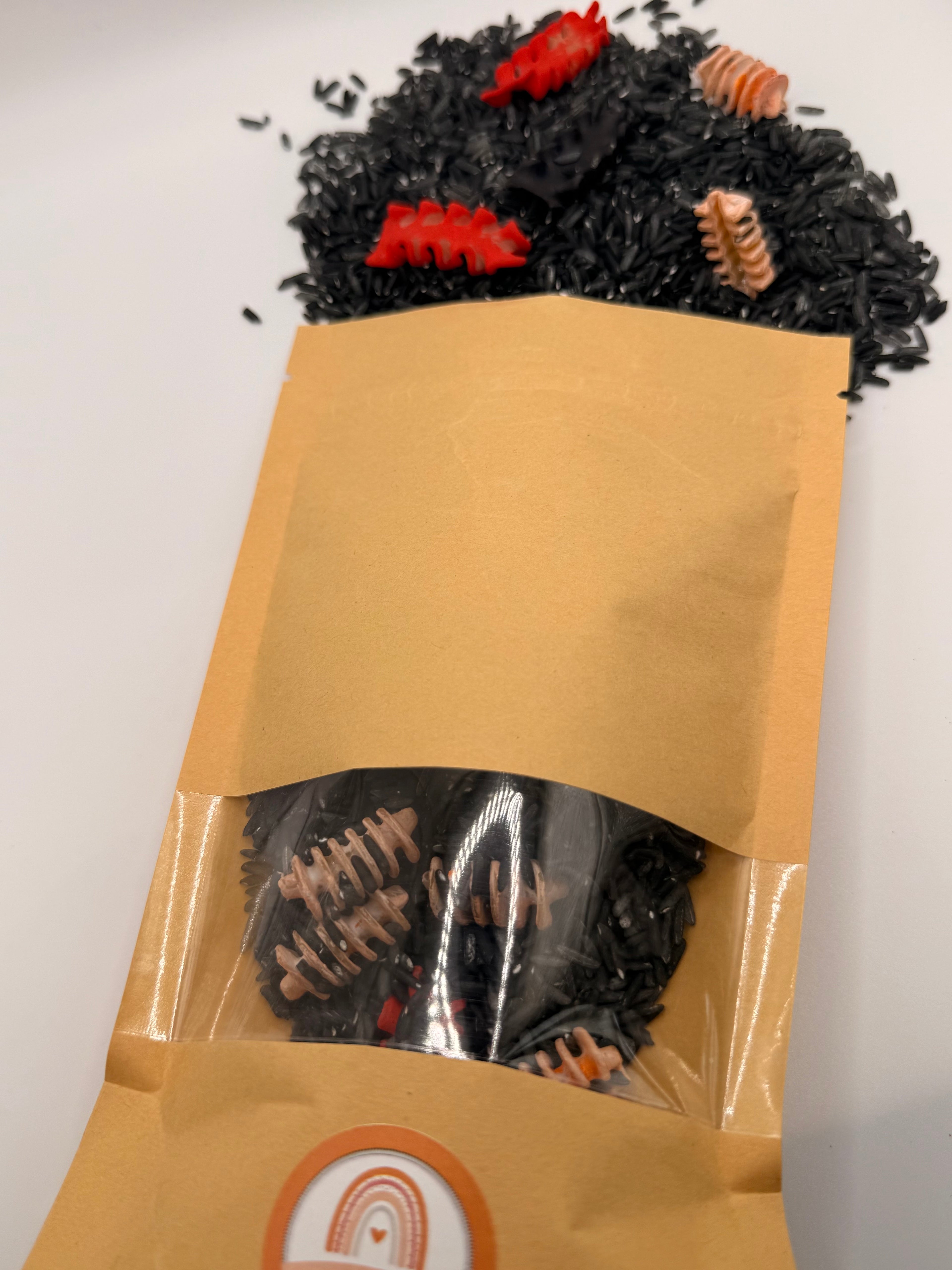 Reusable pouch filled with the Zombie Bones Halloween sensory play mix for messy play and fine motor activities.